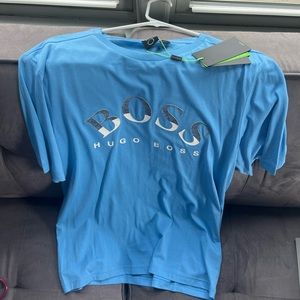 hugos boss shirt fits tight so more like a L-M